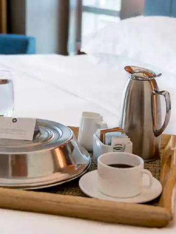 Multi | Cup of coffee on a serving tray in a hotel room.