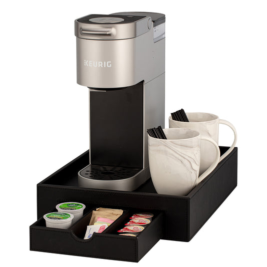 Black | Keurig coffee maker with two mugs and a drawer of coffee pods on a white background