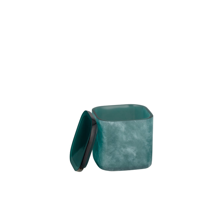 Turquoise | A square teal resin container with a matching lid leaning against it, shown on a plain white background.