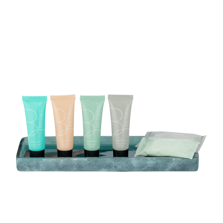 Turquoise | Four personal care tubes in teal, peach, mint, and gray, arranged on a teal tray next to soap bars on a white background.