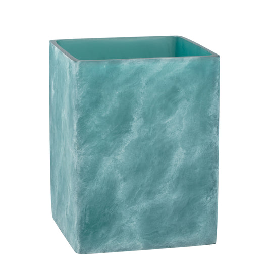 Turquoise | A square-shaped teal resin wastebasket with a textured, ocean wave-like pattern, shown on a plain white background.