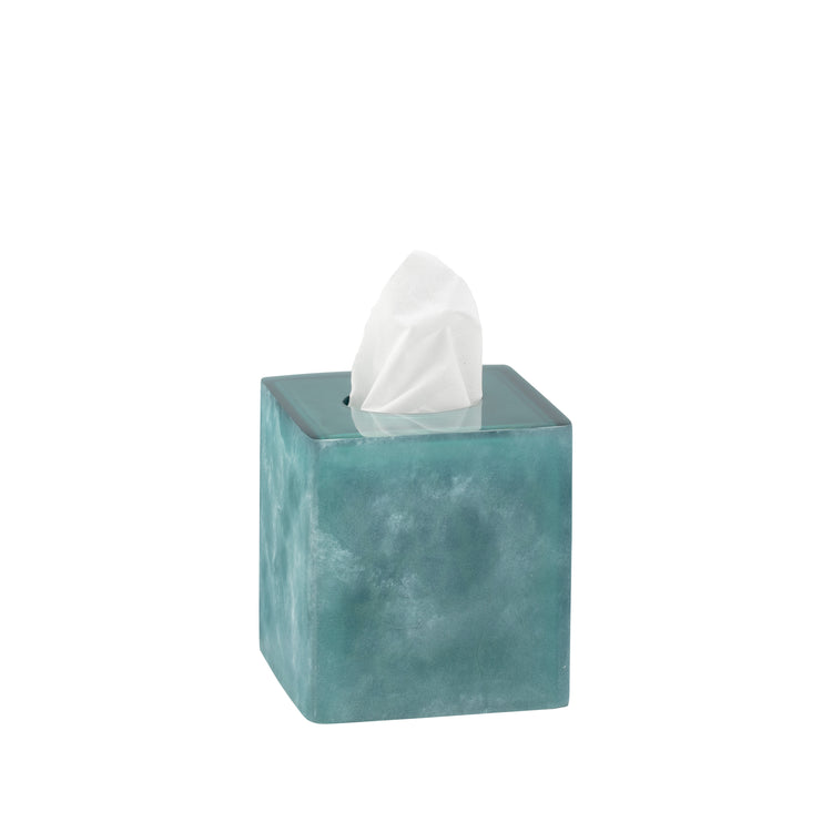 Turquoise | A square tissue box cover in a textured teal blue-green finish, with a white tissue paper partially pulled out from the top opening, set against a plain white background.