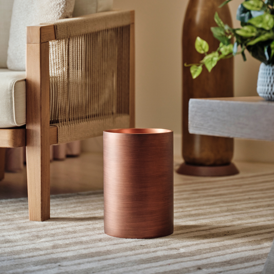 Oil Rubbed Bronze | 9qt wastebasket sitting on a hotel room floor.