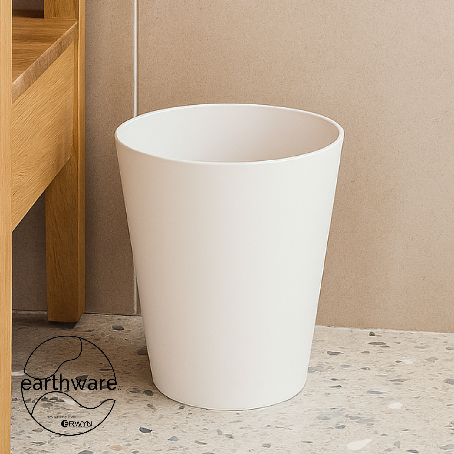 White | Round wastebasket on a terrazzo bathroom floor.